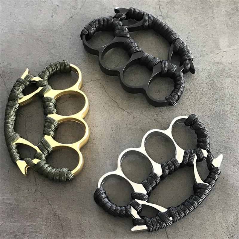 Three knuckle dusters stacked with black paracord grips in gold black and silver