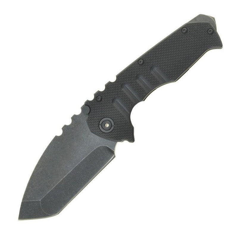 The open knife with a black textured G10 handle on white, showing finger grooves across the grip and a pivot with a brass-toned centre, above the stonewashed blade.