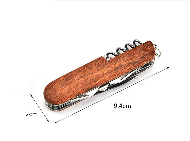 Closed folding multi-tool with wood-grain handle shown between dimension arrows marking folded length and width