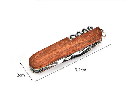 Closed folding multi-tool with wood-grain handle shown between dimension arrows marking folded length and width