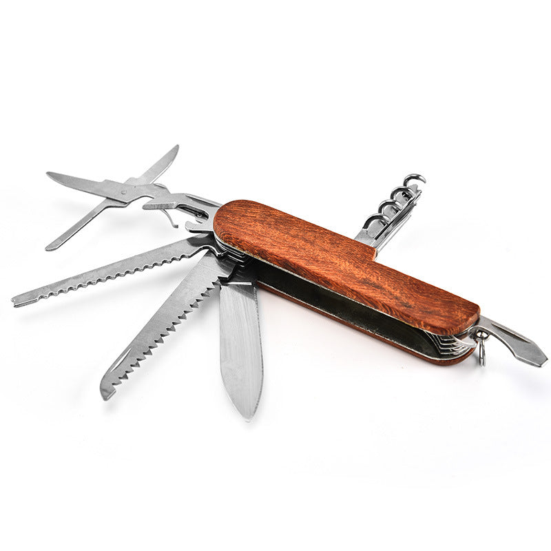Folding multi-tool laid open in a full fan with scissors at one end and the corkscrew raised at the other