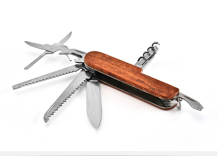 Open folding multi-tool with grained handle showing saw blades, scissors and corkscrew across a white backdrop