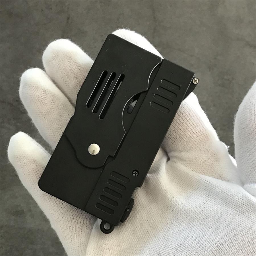 Folded stun gun resting in a gloved palm showing the compact closed form, hinge pin and lanyard hole