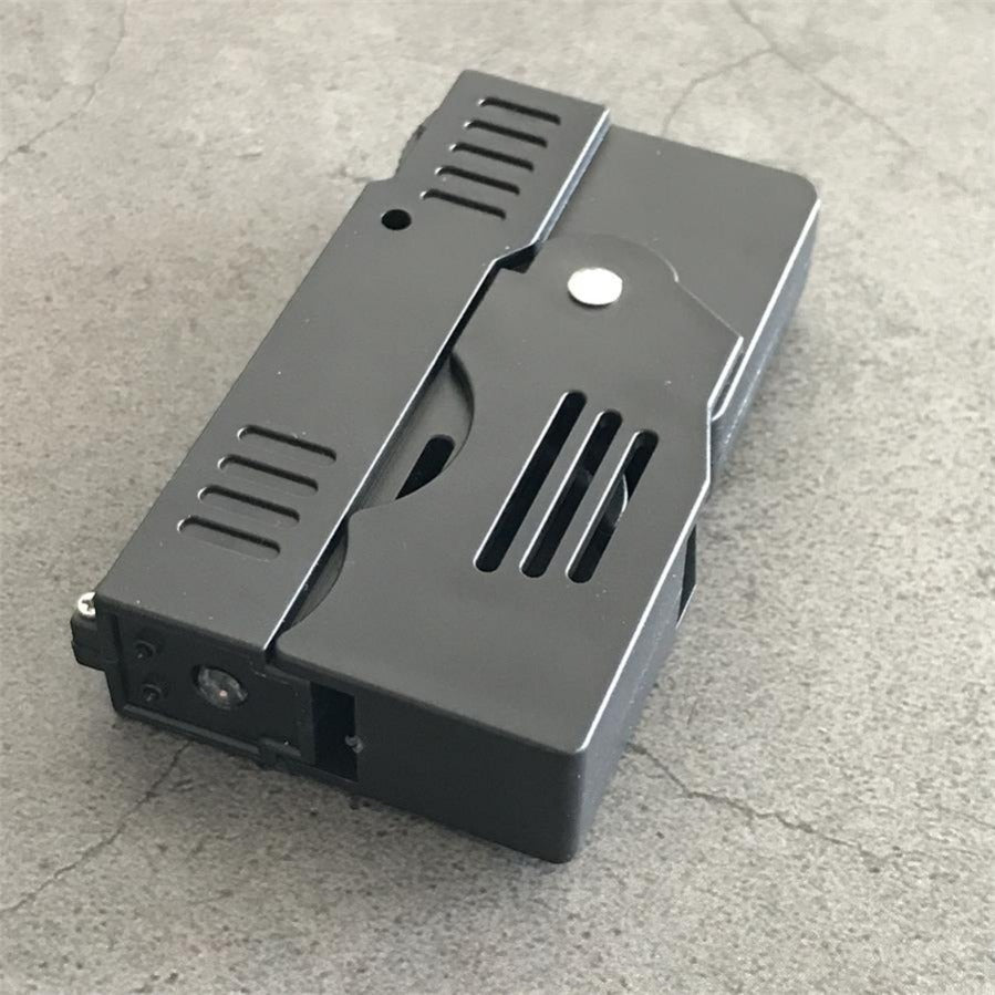 Folded stun gun angled view showing the LED lens and electrode recessed in the nose of the matte black body