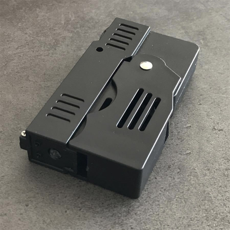 Folding stun gun shown in both states with the grip unfolded above and the unit folded flat below on concrete