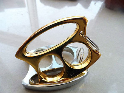Golden and Silver two-hole knuckle dusters stacked on a reflective surface.