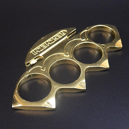 Gold knuckle duster lying flat showing the peaked shoulders and curved arrow engravings