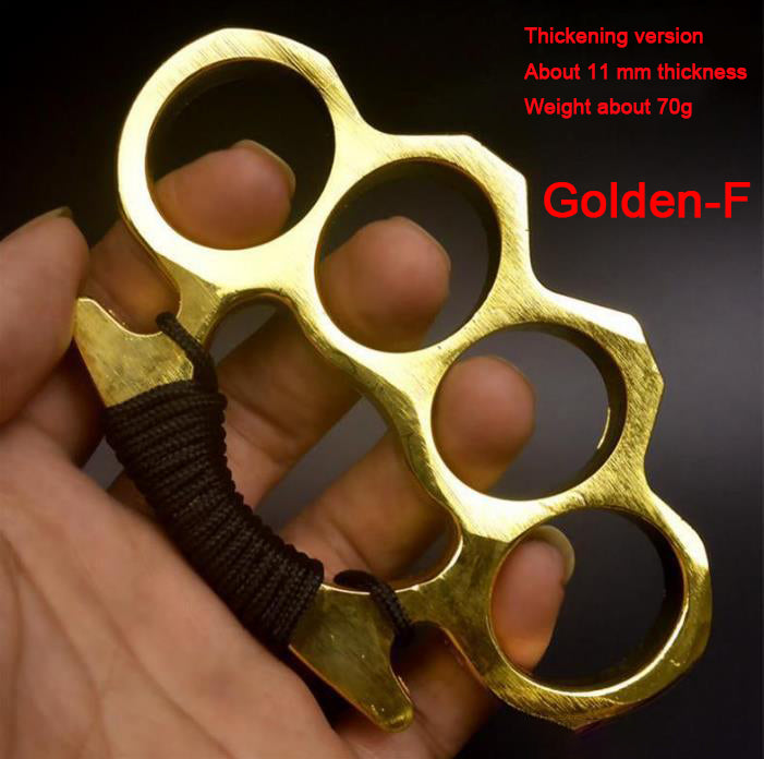 Golden-F aluminum knuckle duster on camouflage fabric and grass with 70 g text overlay