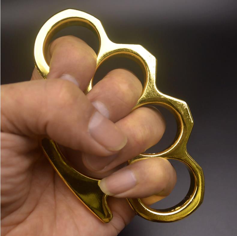 Golden-F aluminum knuckle duster held in hand showing grip detail