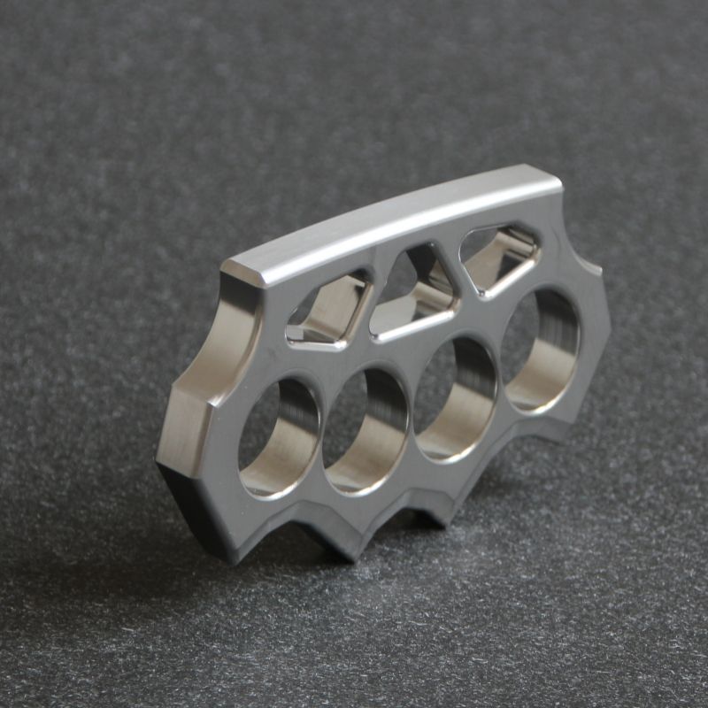 Side angled view of the grass shaped stainless steel knuckle duster showing beveled edges.