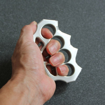 Hand holding the grass shaped stainless steel duster to demonstrate finger hole size.