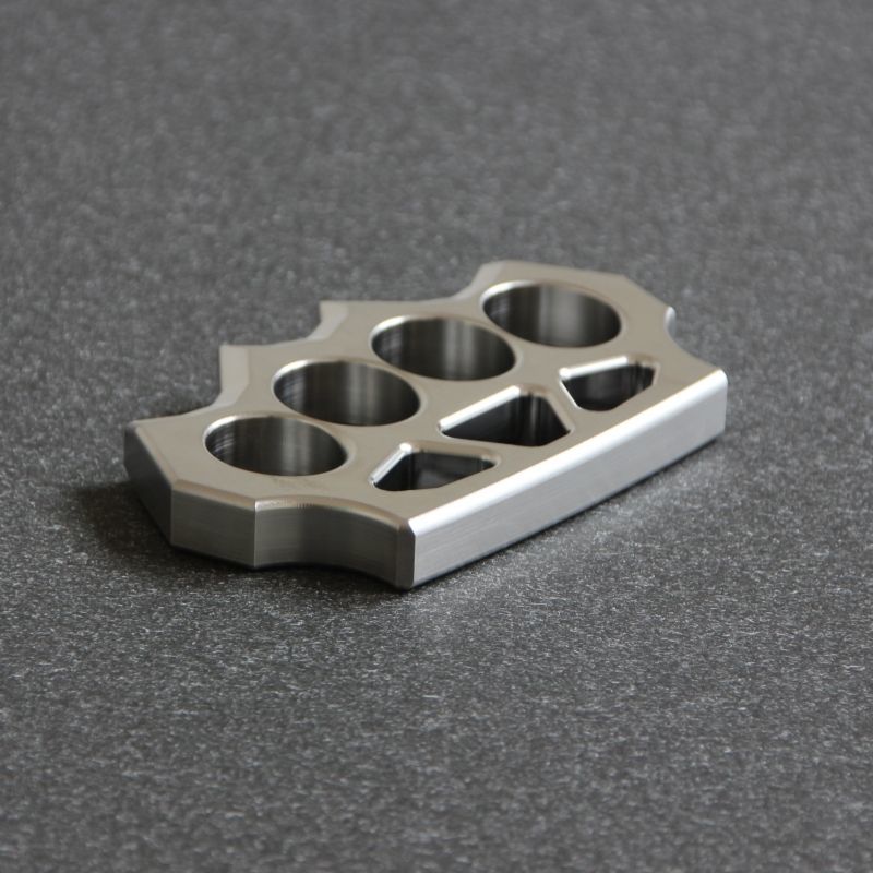 Low angled shot of the grass shaped stainless steel duster on dark surface.