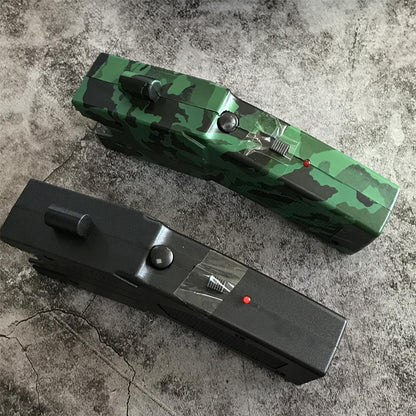 Top view of the green camouflage and black stun gun units showing the raised safety and launch toggles, round button and red LED indicator
