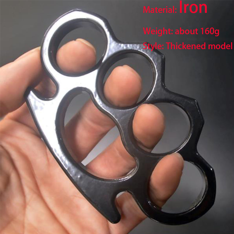 Black thickened iron knuckle duster with a glossy black finish held in a hand