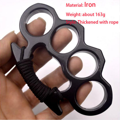Black thickened iron knuckle duster with a rope-wrapped handle held in an open hand