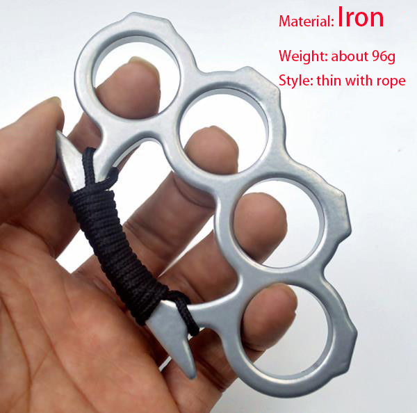 Silver thin iron knuckle duster with black rope wrapped around the handle, held up in an open hand