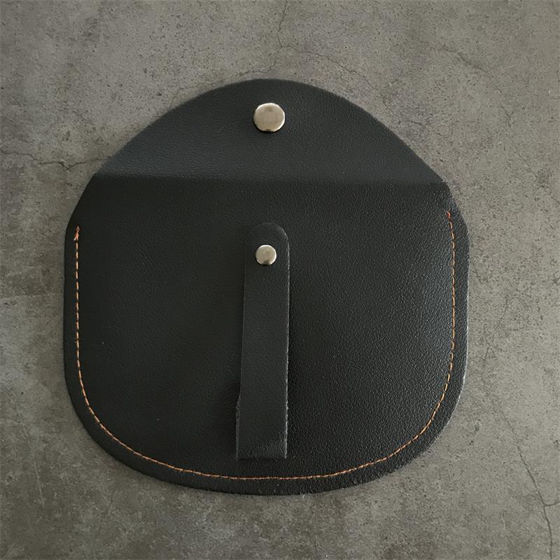 Rear panel of the black leather case with a slim snap-closed leather strap running down the center