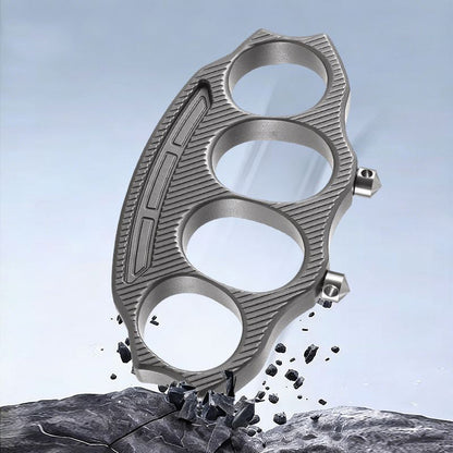 Knuckle duster striking rock with debris flying, demonstrating glass-breaking impact