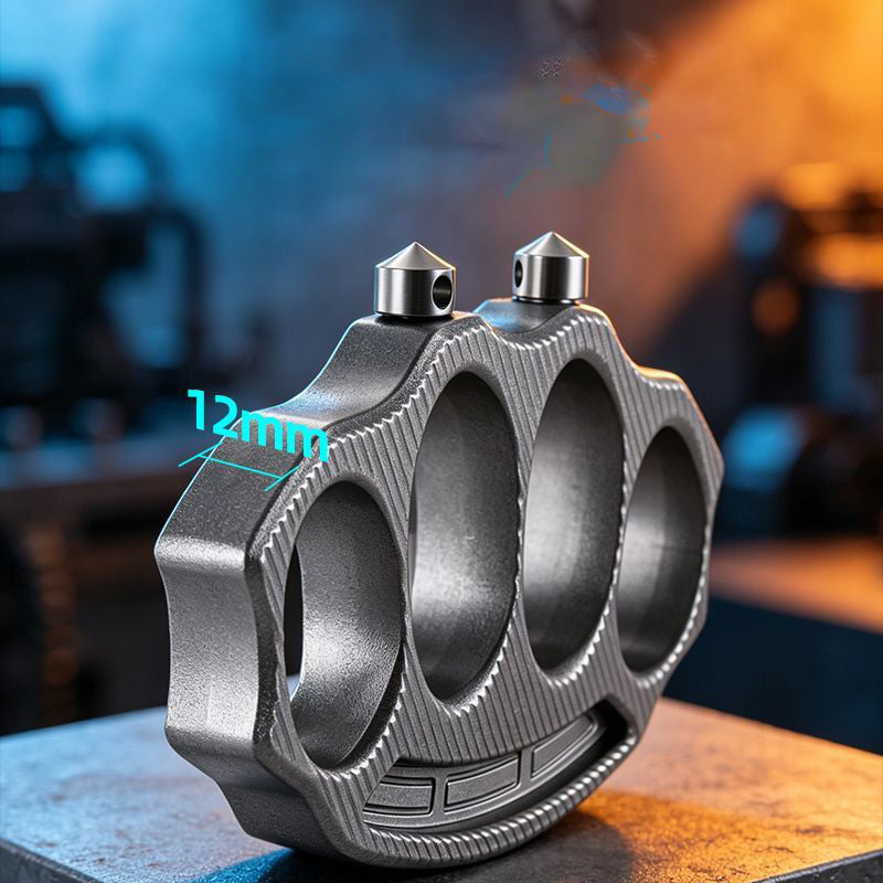 Knuckle duster standing on edge with 12mm thickness label in workshop lighting