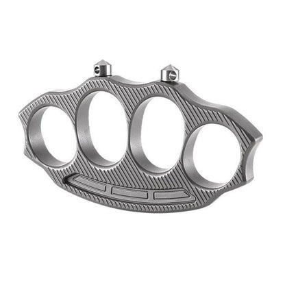 Knuckle duster top view on white background showing four finger holes and twin cone points