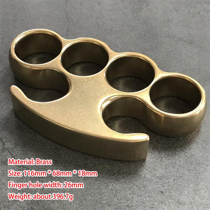 Large brass knuckle duster front view, four round holes and claw tips, with size markings overlaid in red