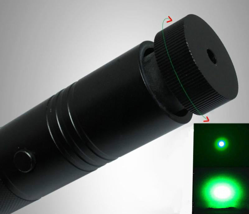 Laser pen head with the focus ring set wide, the beam spreading into a broad green patch