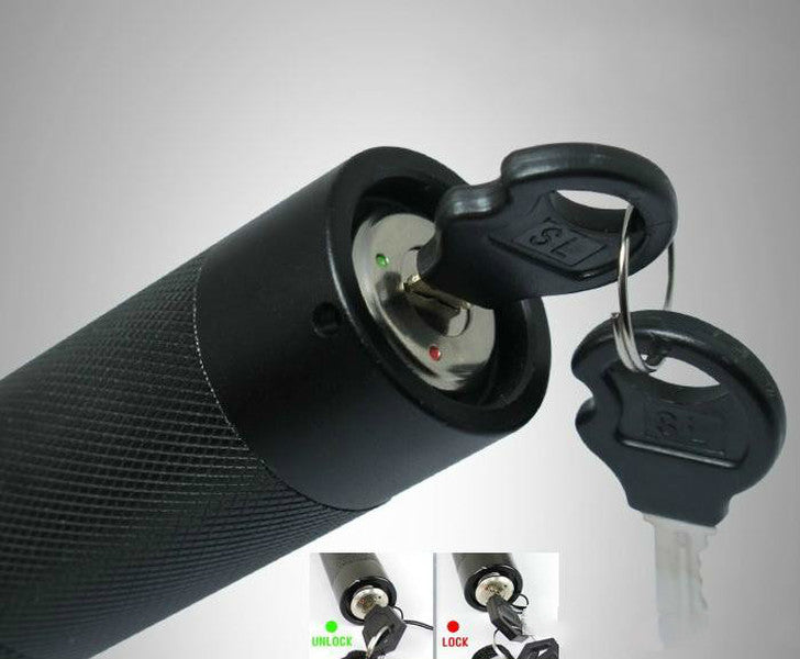 Close-up of the laser pen tail cap with the key inserted between the locked and open positions