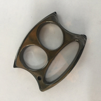 Light black two-hole zinc alloy knuckle duster laid flat on a plain white surface.