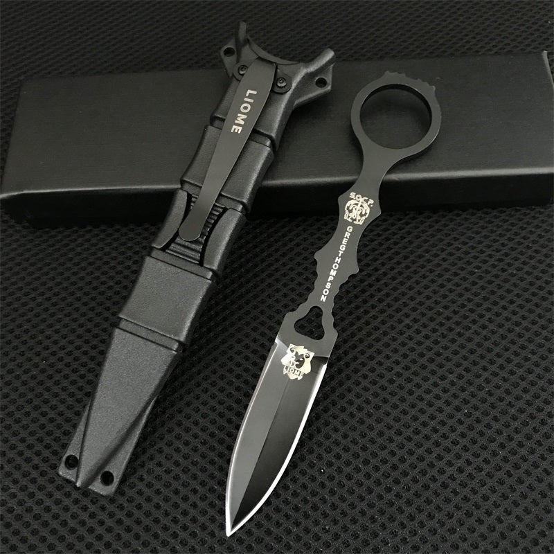 Black Liome 176 fixed-blade knife and sheath resting on a black box