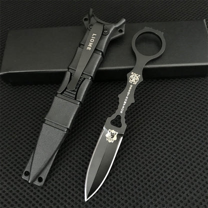 Black Liome 176 fixed-blade knife and sheath resting on a black box