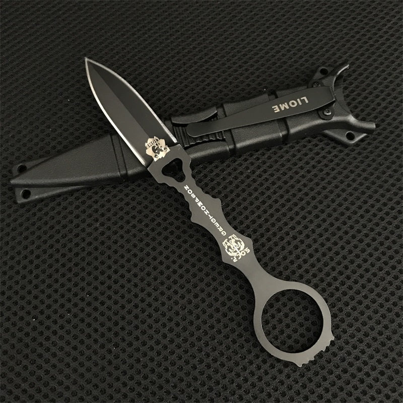 Close-up of the black Liome 176 skeleton knife lying across its molded sheath