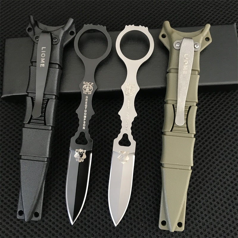 Liome 176 fixed-blade knives in black and silver with matching nylon sheaths arranged on black mesh