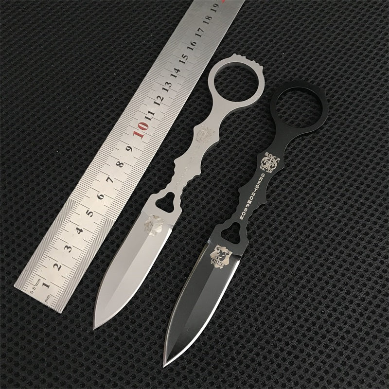 Black and silver Liome 176 knives laid next to a metal ruler showing overall length