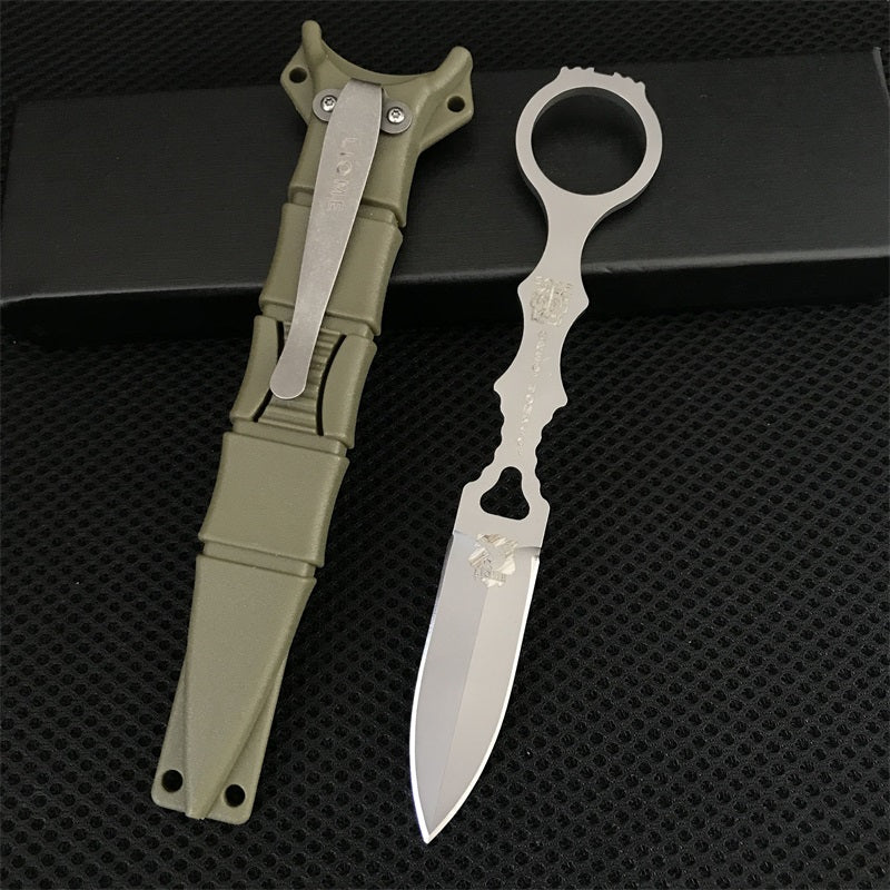 Close-up of the silver Liome 176 skeleton knife with its tan nylon sheath