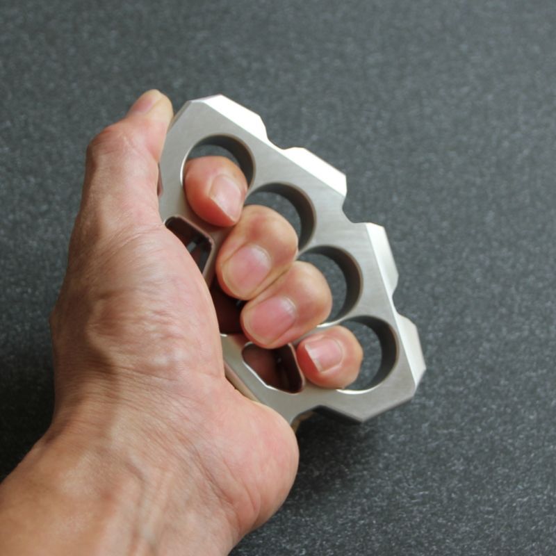 Hand gripping the maple leaf shaped stainless steel duster to show finger hole fit.