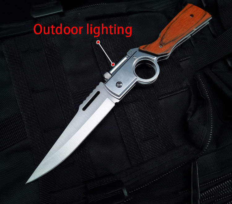 Single medium wood-handle folding knife open on black tactical fabric with Outdoor lighting callout