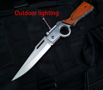 Single medium wood-handle folding knife open on black tactical fabric with Outdoor lighting callout