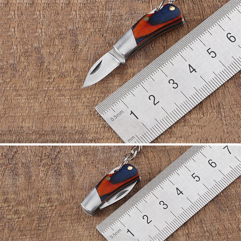 A two-panel size comparison of the mini folding knife beside a metal ruler - open at about 5 cm in the top panel and closed at about 3 cm in the bottom one, both with a navy-and-orange wood handle.