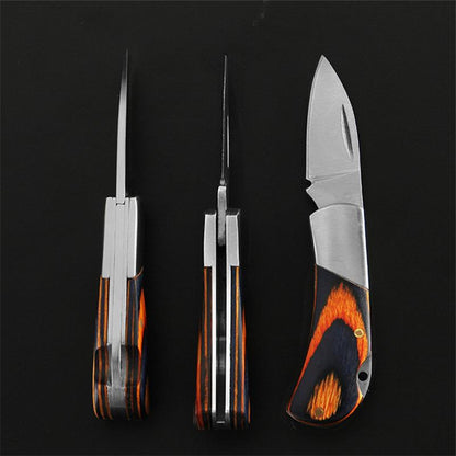 Three views of the mini folding knife on a black background - closed from the back, closed edge-on, and open from the side - showing the layered steel spine, the navy-and-orange wood scales and the drop-point blade.