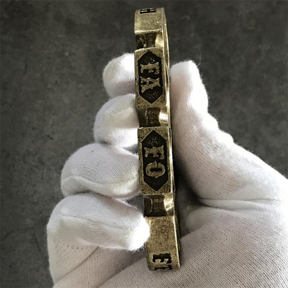 Edge profile of the antique copper retro knuckle duster showing thickness and side markings