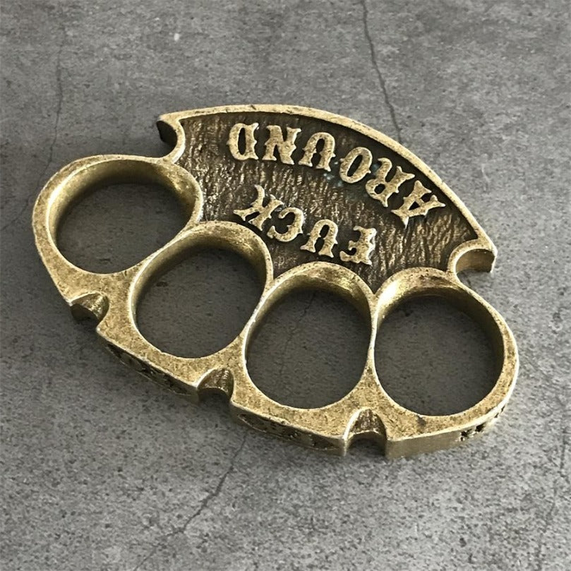 Antique copper retro knuckle duster rotated top view showing curved palm rest and lettering