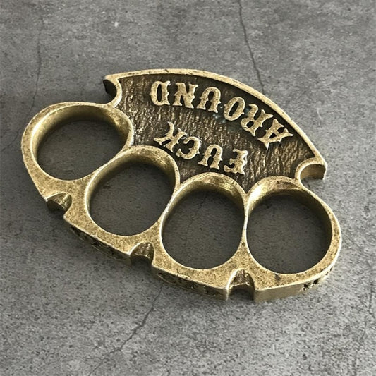 Antique copper retro knuckle duster rotated top view showing curved palm rest and lettering