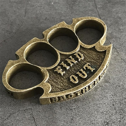 Antique copper retro knuckle duster three-quarter view showing FIND OUT and BROTHERHOOD lettering