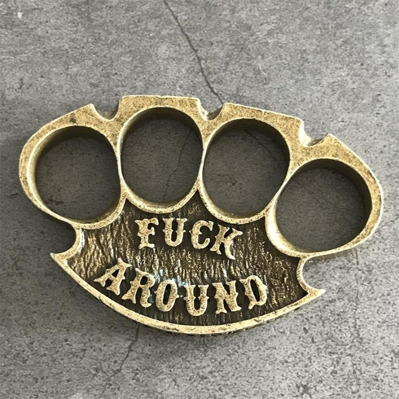 Antique copper retro knuckle duster top view showing four finger holes and raised lettering