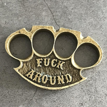 Antique copper retro knuckle duster top view showing four finger holes and raised lettering