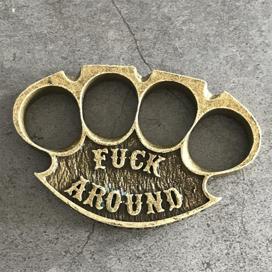 Antique copper retro knuckle duster top view showing four finger holes and raised lettering