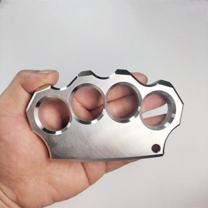 Fingers inserted through the four holes of the mirror polished stainless steel knuckle duster, grip demonstration.