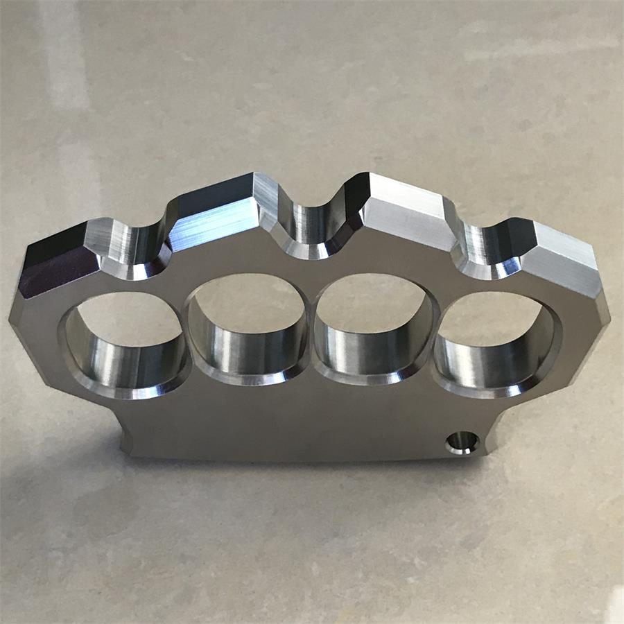 Front-on edge view of the mirror polished four-hole duster showing thickness and hole depth.