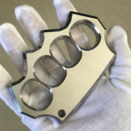 White-gloved hand holding the mirror polished four-hole duster straight on, showing hole alignment.