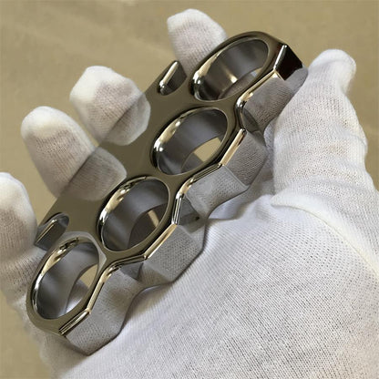 White-gloved fist worn through the four finger holes of the mirror-polished steel knuckle duster